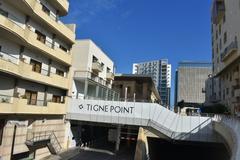 Tigne Point coast with buildings and cloudy sky