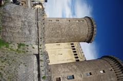 Exterior view of Castel Nuovo in Naples, Italy showcasing Gothic and Renaissance architecture.