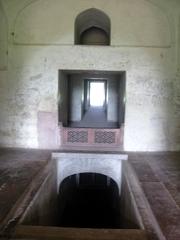 Mariam's Tomb with surrounding greenery and clear blue sky