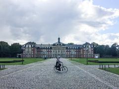 Bike rider in front of Fürstbischöfliches Schloss Münster