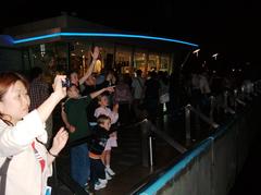 spectators on Tsim Sha Tsui waterfront watching A Symphony of Lights in Hong Kong