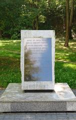 Commemorative stone with a plaque at the base of the Warsaw Uprising Mound