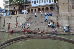 A scenic view of Varanasi Ganges River with boats and people