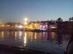 a serene view of the ghats of the Varanasi city on the banks of the Ganges river under a cloudy sky