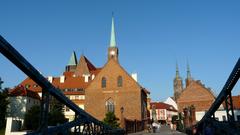 Most Tumski in Wrocław, Poland at dusk with lights reflecting off the Odra River