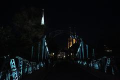 Most Tumski at night with illuminated bridge and city skyline