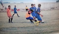 A group of community college students playing sports on a green field