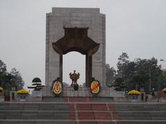 War Memorial Hanoi with lush greenery and people paying respects