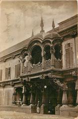 Postcard of doorway with carved woodwork in Poona