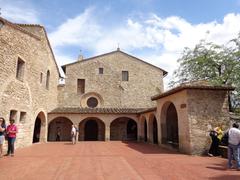 View of San Damiano monastery in Assisi, Italy, surrounded by trees and greenery