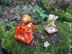 Buddhist and Hindu statuary assemblage with offerings at Buddhapadipa Temple