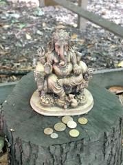 Buddhist and Hindu statuary with offerings at Buddhapadipa Temple grounds