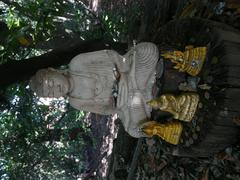 Buddhist and Hindu statues with offerings in Buddhapadipa Temple grounds