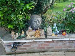 Buddhist and Hindu statuary with offerings at Buddhapadipa Temple in Wimbledon