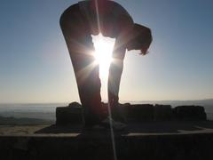 woman doing yoga pose on Mount Bhuj with beautiful sunrays