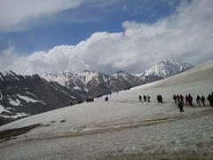 Pilgrims walking to holy caves on snowy mountain