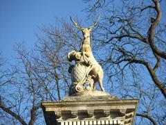 Gates to Wimpole Hall with heraldic stag emblem