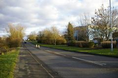 Clapgate Lane with Woodgate Valley Urban Farm and Country Park on the left and Woodgate Business Park on the right