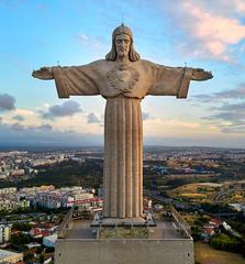 Sanctuary of Christ the King statue in Almada, Portugal with blue sky