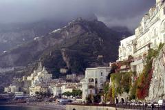 A scenic view of the town of Amalfi under cloudy skies