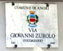 White marble road plaque dedicated to Giovanni Zurolo