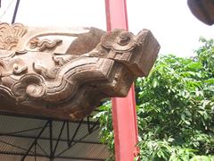 the head of a transverse beam under restoration at Bảng communal house