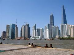 Huangpu River embankment with a view of Pudong district skyscrapers Jin Mao Tower and Shanghai World Financial Center