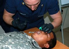 U.S. Coast Guard EMT demonstrates emergency nasopharyngeal airway insertion on Malaysian Coast Guardsman during training