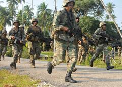 Malaysian Army soldiers and U.S. Marines disembarking from amphibious assault vehicles during a joint exercise