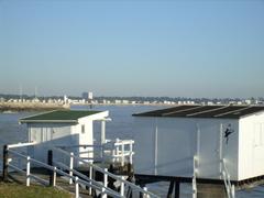 Traditional fishing huts called carrelets with nets over the water in Royan at sunset