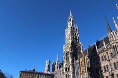 Glockenspiel Neues Rathaus Munich with towers of Frauenkirche and Mariensäule