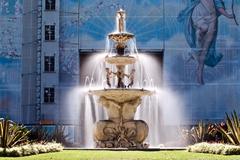 Hochgurtel Fountain in Autumn sun with Royal Exhibition Building restoration in Carlton Gardens, Melbourne