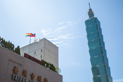 Taipei City Hall and Taipei 101 top view with Rainbow Flag, ROC Flag, and Taipei City Flag on rooftop