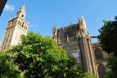 Aerial view of Seville featuring landmarks like the Cathedral and La Giralda