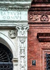 Close photo of the portal and window of palazzo Bagatti Valsecchi in via Santo Spirito 7, Milan