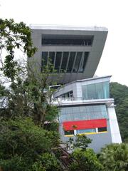 Side view of the Peak Tower at Victoria Peak, Hong Kong with visible Peak Tram rails