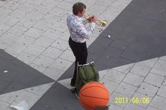 Skillful trumpeter performing at Sergels Torg on a warm Monday evening, Sweden's National Day