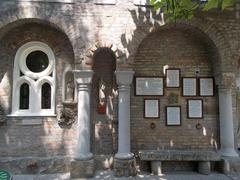 Front garden of Bory Castle featuring 'Speak stones' description in seven languages and arches, pillars, columns, statues, windows