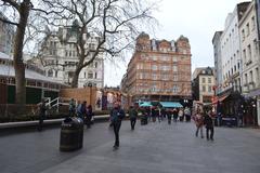 Leicester Square in London with people walking and relaxing