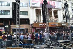 Leicester Square in London on a bright day with people walking