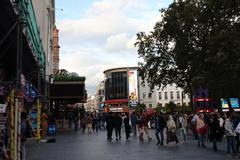 Leicester Square in London filled with people and surrounded by buildings