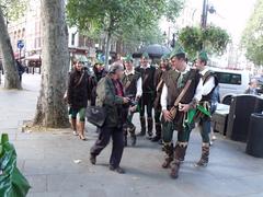 Man photographing group dressed as Robin Hood in London