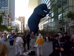 Cops, vendors, convention-goers, and a Big, Blue Bear at a convention