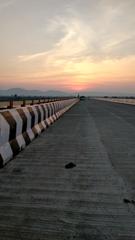 Sunset in Chandrapur with a green field in the foreground