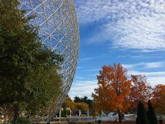 Montreal Biosphère with autumn foliage and reflecting pool