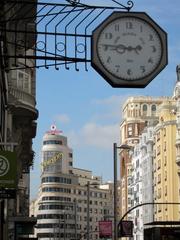 Night view of Gran Vía in Madrid with illuminated buildings and bustling streets