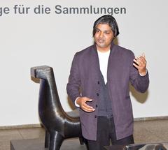 Indian designer Satyendra Pakhalé at the Museum of Applied Art in Cologne explaining his sculpture Bell Metal Horse Chair