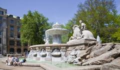 Wittelsbacher Fountain with a paper face statue at Lenbachplatz in Munich, Germany