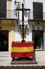 Crucifix and Spanish flag on a wall in Spain