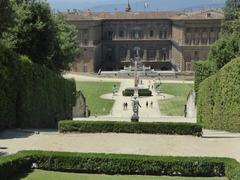 A serene view of the Giardino di Boboli with lush greenery and statues